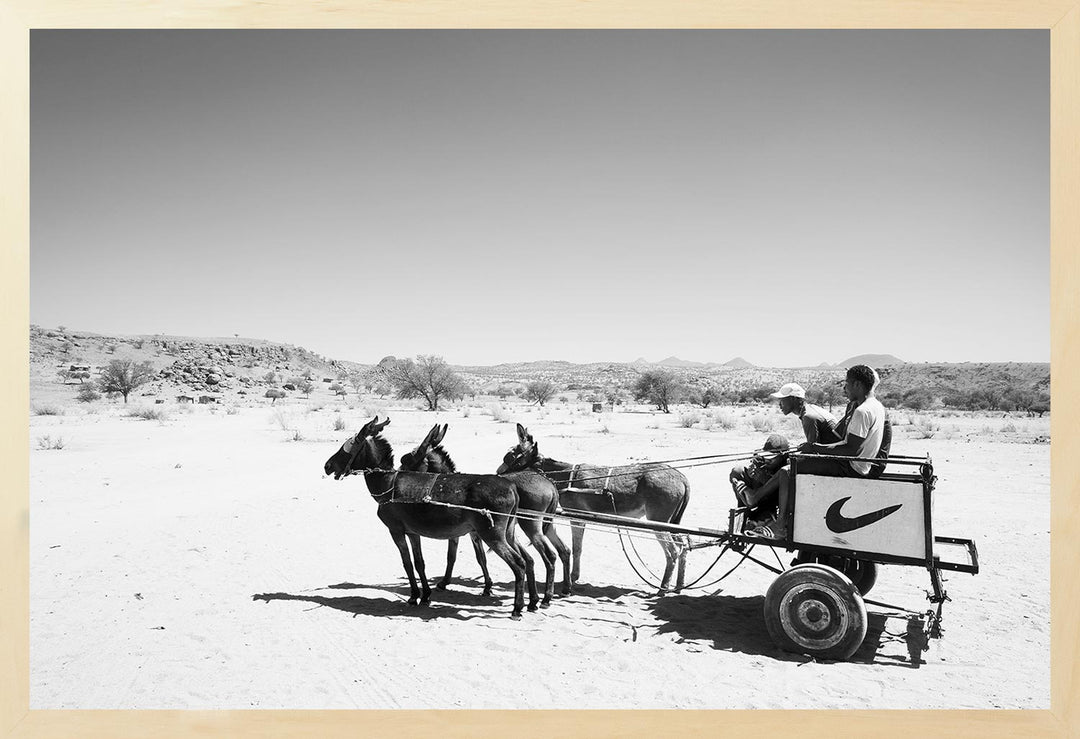 Black and white photograph of a donkey cart in a desert landscape, part of The Desert Wanderers Collection.