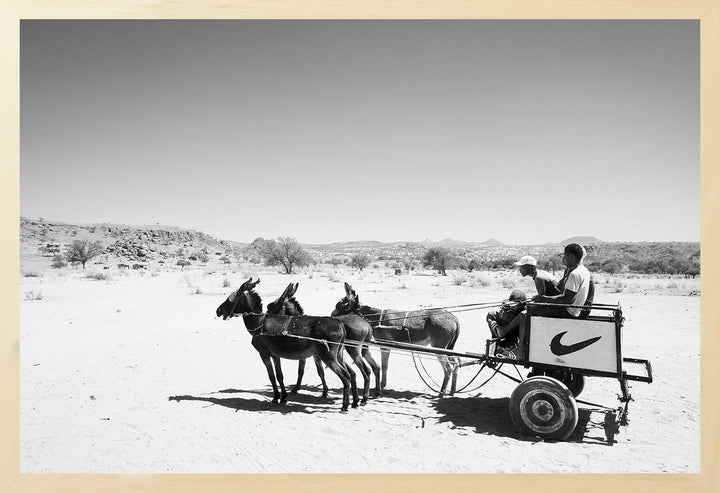 Black and white photograph of a donkey cart in a desert landscape, part of The Desert Wanderers Collection.